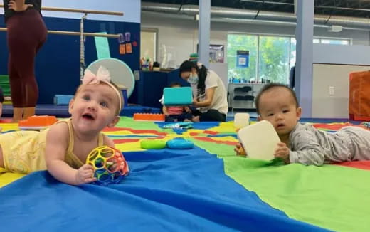 a couple of children sitting on a bed