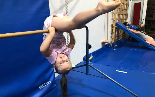 a person doing a handstand on a trampoline