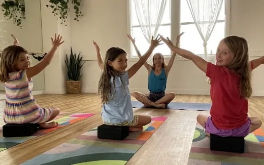 a group of children doing yoga