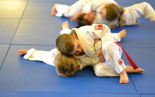 a group of children in karate uniforms