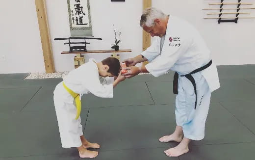 a man and a boy in karate uniforms