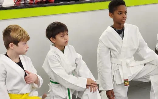 a group of boys in karate uniforms