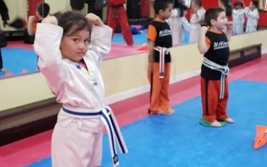 a group of kids in karate uniforms