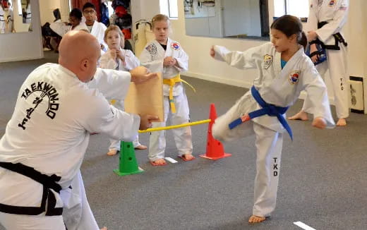 a group of people in karate uniforms