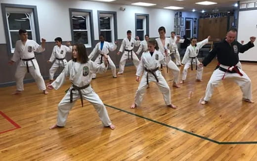 a group of people in karate uniforms