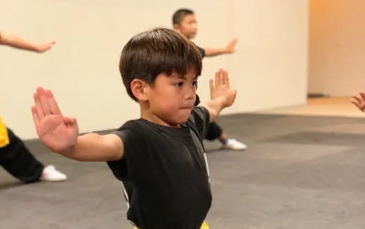 a boy with his hands up