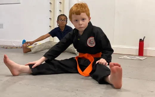 a boy sitting on the floor