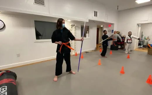 a group of people holding bows and arrows in a room