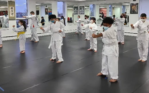 a group of people in white karate uniforms