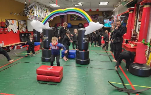 a group of people playing in a room with a large colorful slide