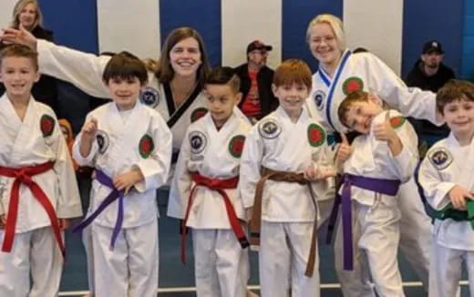 a group of kids in karate uniforms