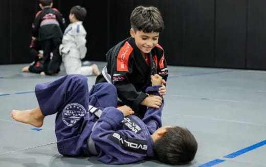 a couple of boys in a wrestling match