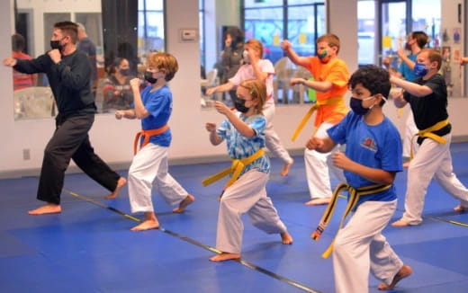 a group of kids practicing martial arts