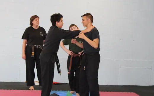 a group of people in black martial arts uniforms