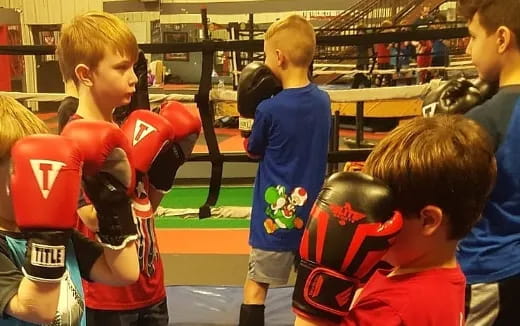 a group of kids in boxing gloves