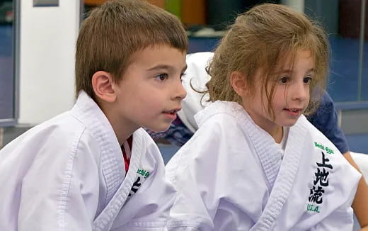 a couple of young boys in white coats