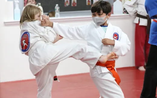 a man and a woman in karate uniforms