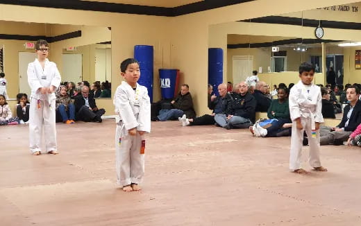 a group of people in karate uniforms