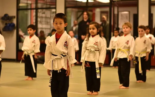 a group of children in karate uniforms