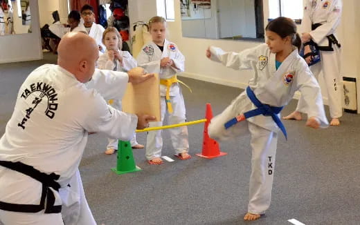 a group of people in karate uniforms