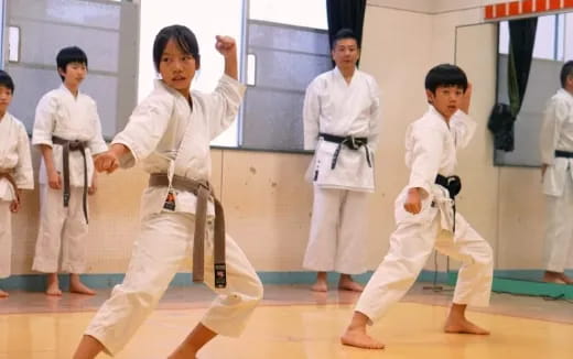 a group of people in karate uniforms