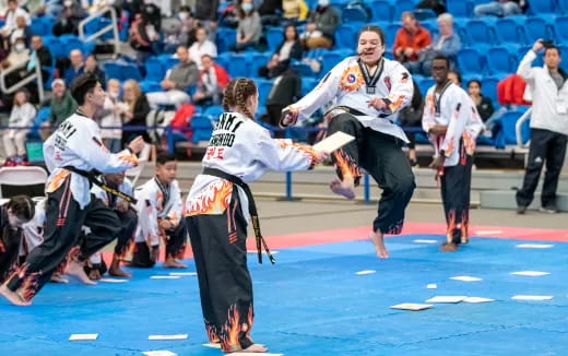 a group of people in karate uniforms