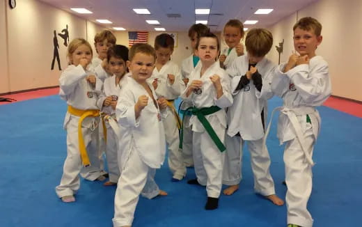 a group of children in karate uniforms