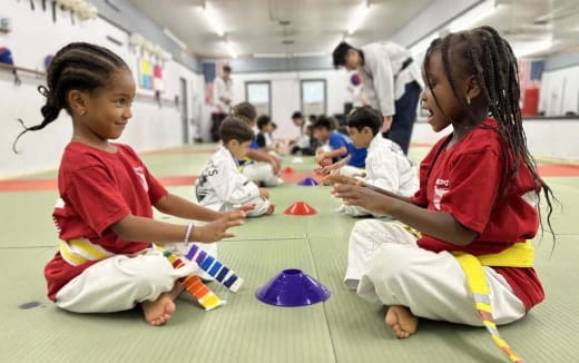 a group of children sitting on the floor playing with toys