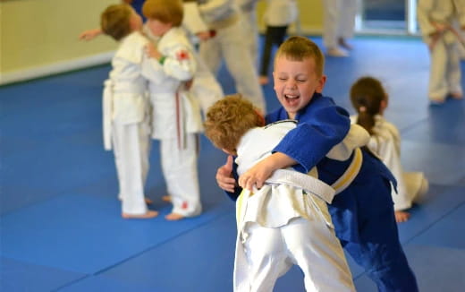 a group of children in karate uniforms