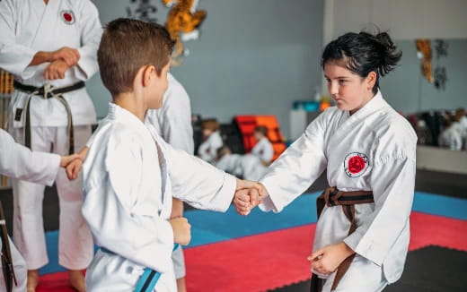 a group of people in karate uniforms