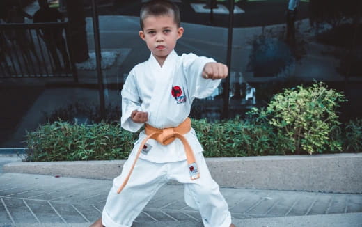 a boy in a karate uniform