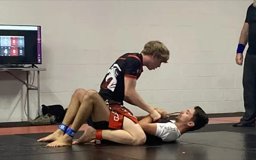a person in a uniform wrestling with another man in a uniform
