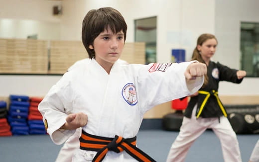 a boy in a karate uniform