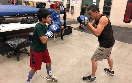 a man and a boy in a gym