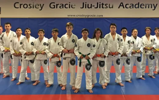 a group of people in white karate uniforms