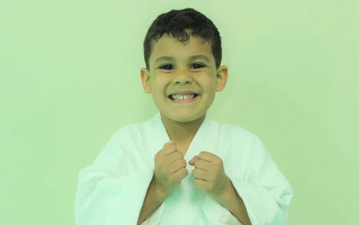 a boy smiling and pointing