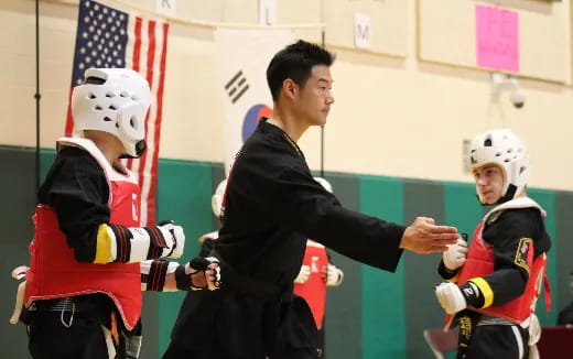 a person shaking hands with a group of people wearing hockey uniforms