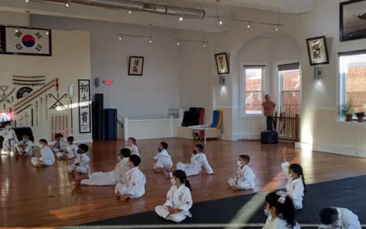 a group of people sitting on the floor in a room