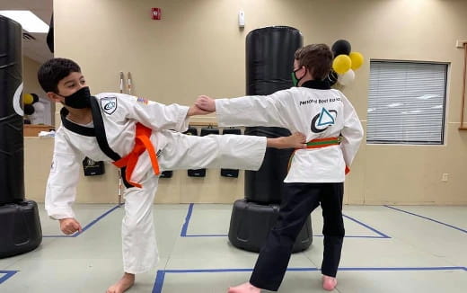 a couple of people in karate uniforms