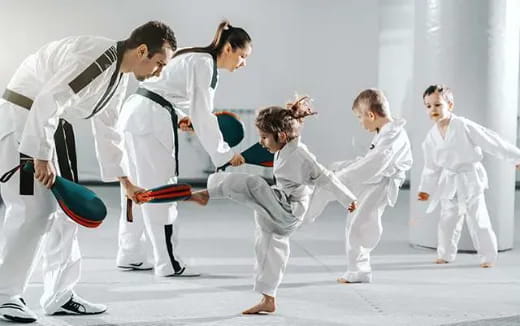 a group of people in karate uniforms