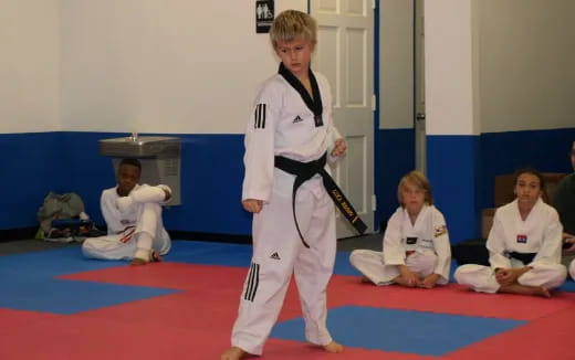 a group of children in karate uniforms