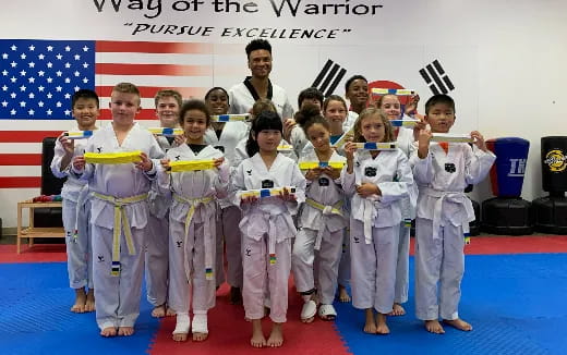 a group of children in karate uniforms