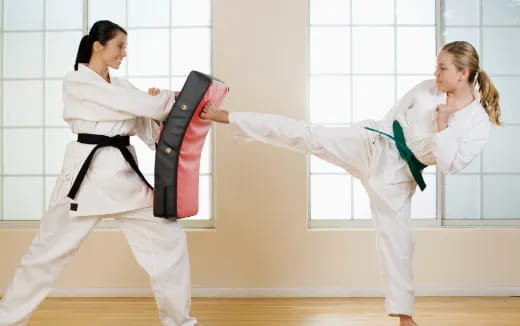 a couple of women in karate uniforms