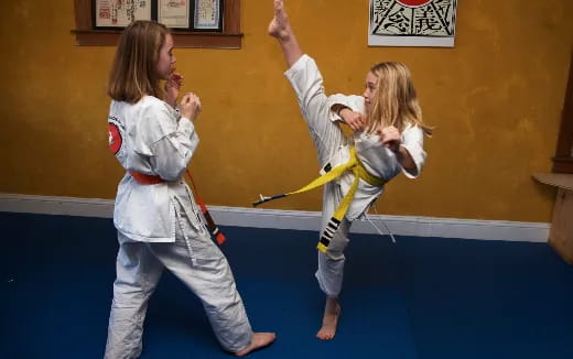 two girls in karate uniforms