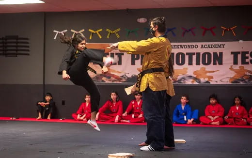 a man and woman dancing on a stage with a crowd watching