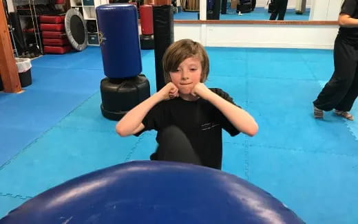 a child sitting on a blue mat