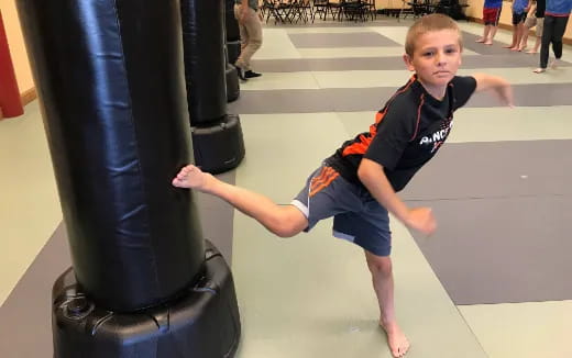 a boy jumping on a trampoline