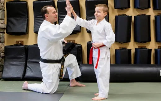 a person and a boy in karate uniforms