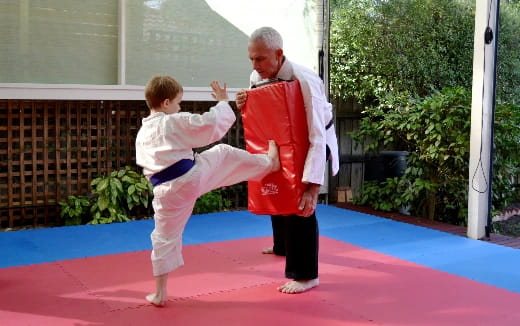 a man and a boy in karate uniforms