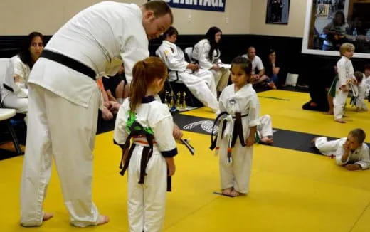 a group of people in karate uniforms